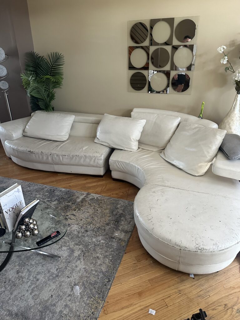 Discolored white leather sofa before restoration