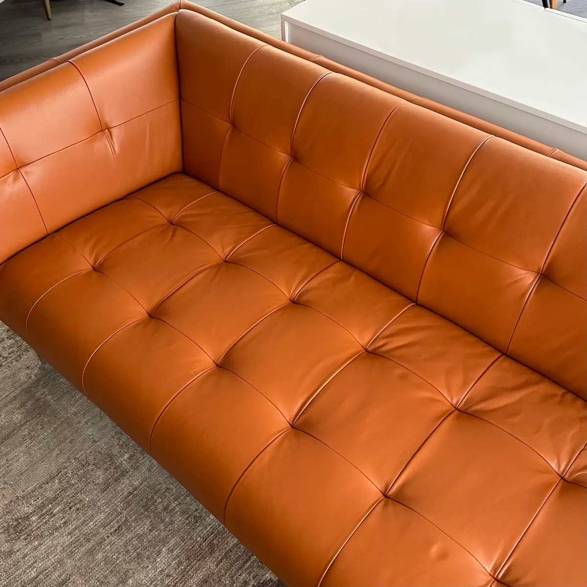 Full sofa recoloring in a bold solid orange (after)