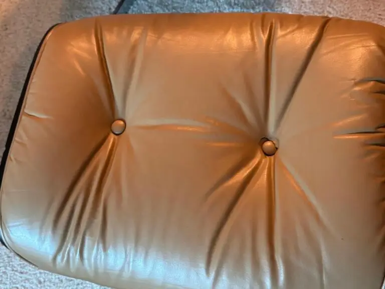 Leather wear around the button on the cushion before repair