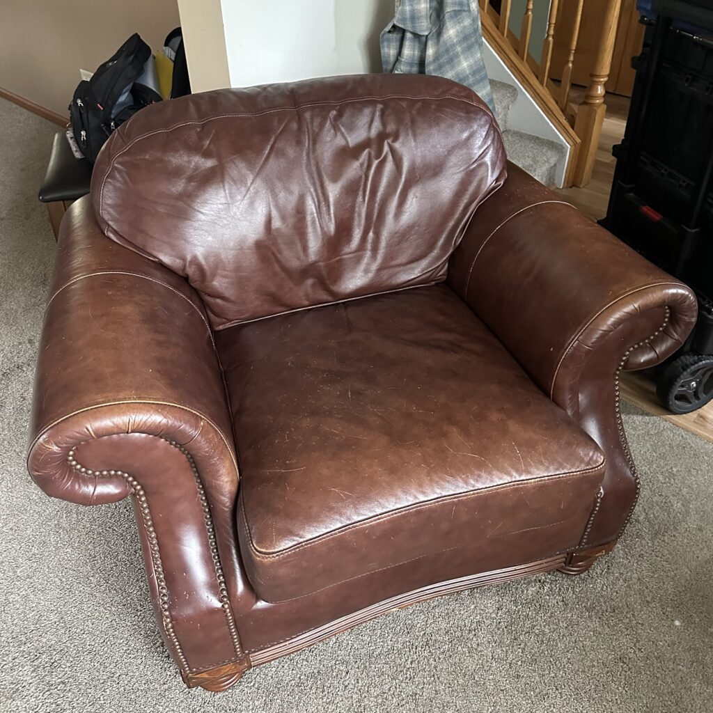 Brown leather armchair scratched by a cat: full restoration (before)