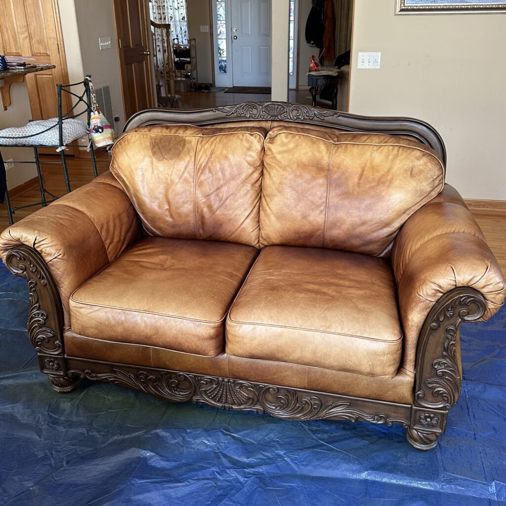 Leather loveseat: body oil removed where heads rest on the back, color restored in a new shade (before)