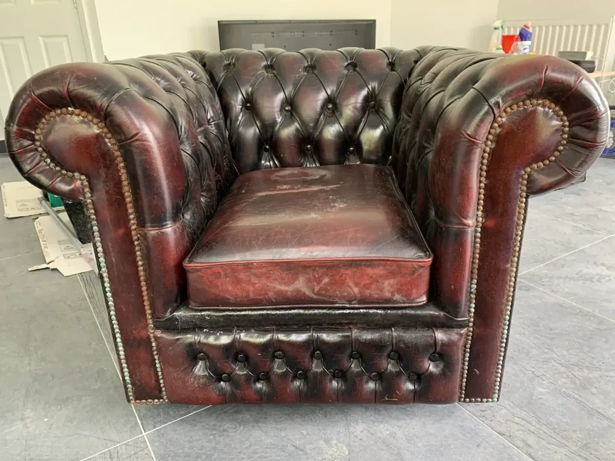 Chesterfield chair restoration with a patina-style finish (before)