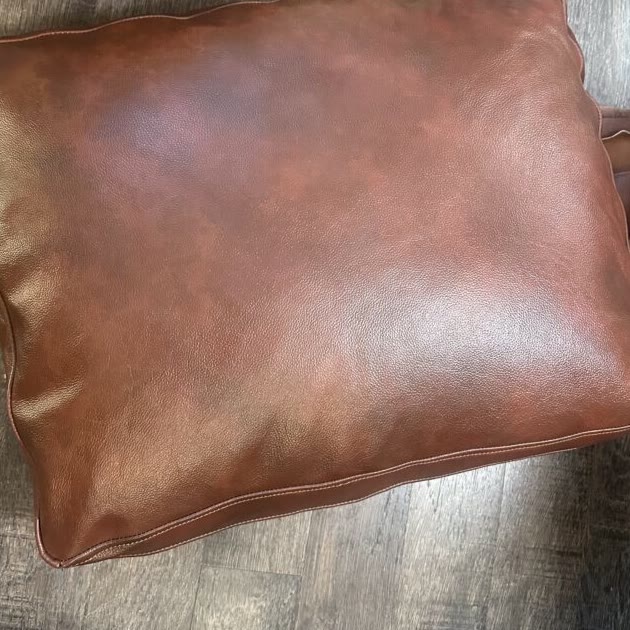 Leather colored by hand to match the sofa, then sewn into a new seat cushion cover (after)